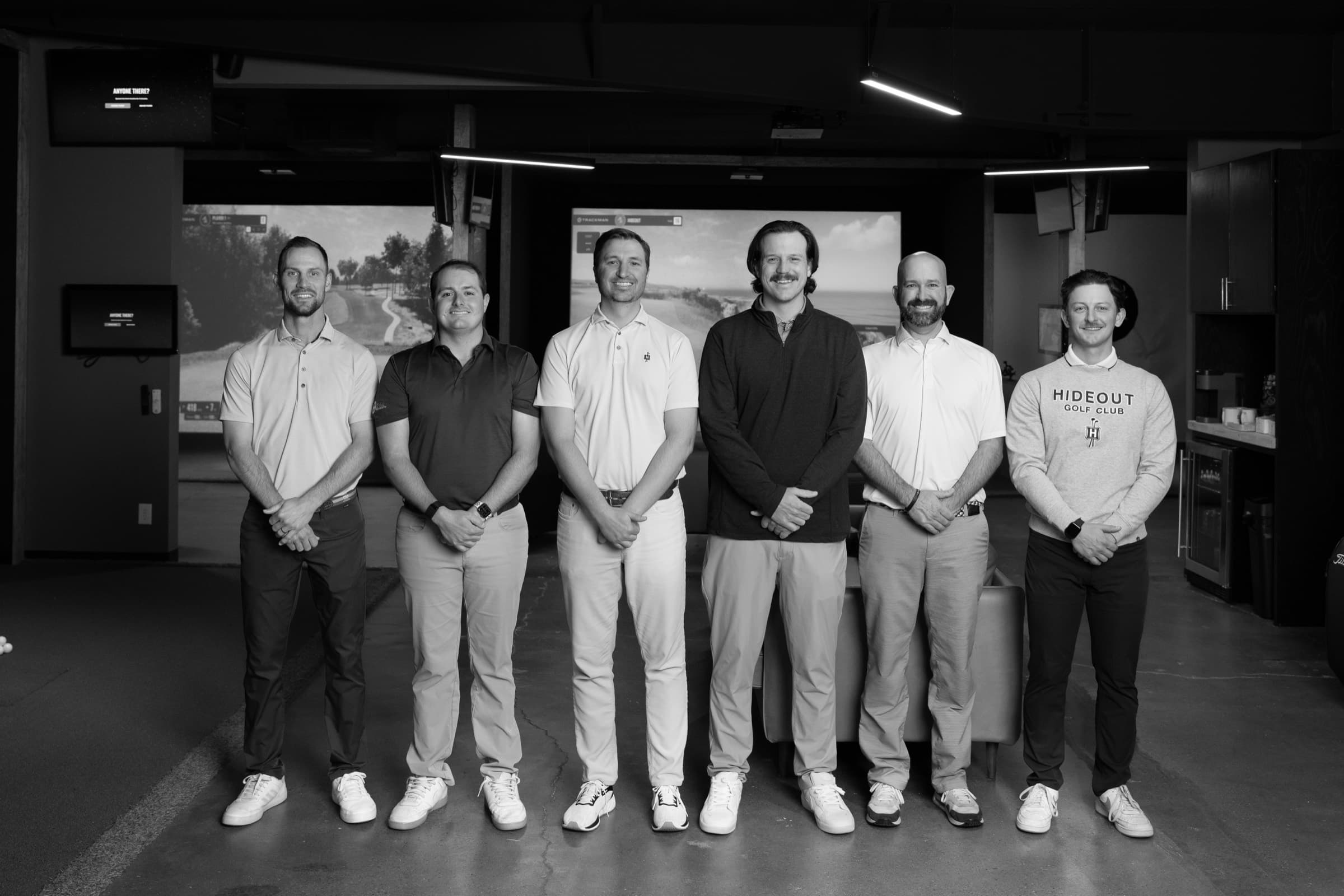 The Profectus Golf coaching team standing together in the Nashville simulator studio
