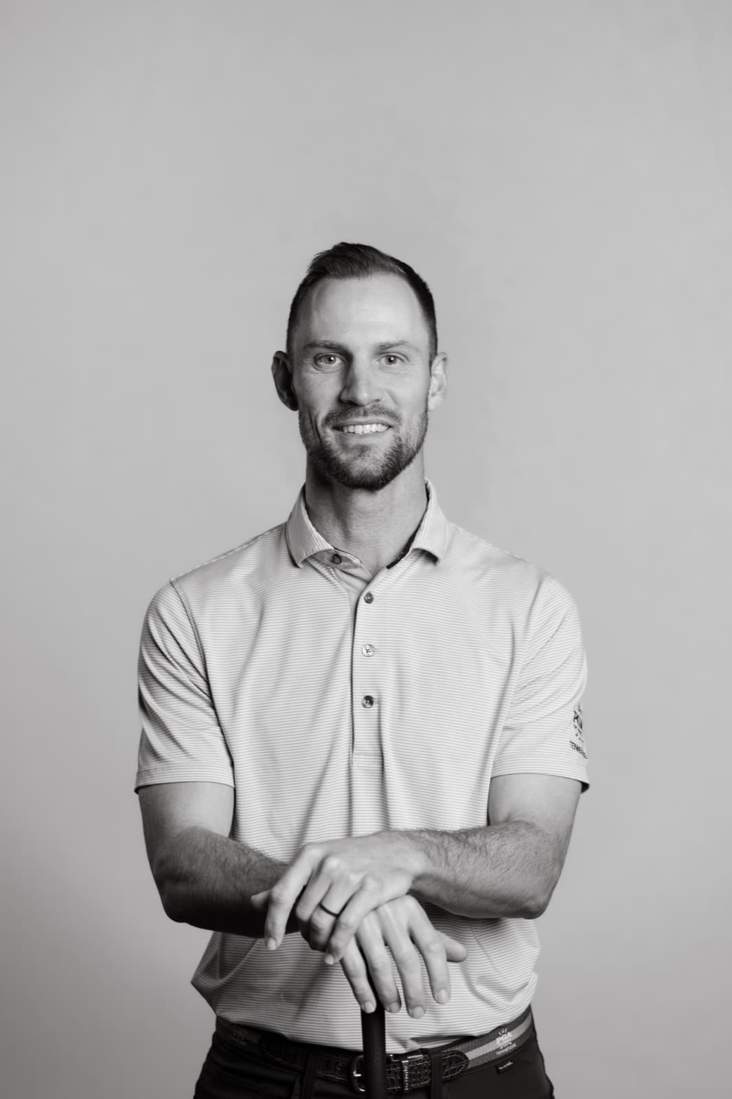 Josh Bevell, PGA Professional and co-founder of Profectus Golf, leaning on a golf club